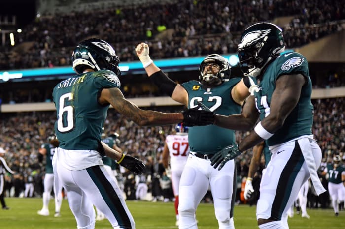 Jason Kelce celebrates with receivers DeVonta Smith and A.J. Brown